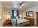 Bedroom with two nightstands, a ceiling fan, wood floors, and neutral walls at 4634 Bigler Ln, Mount Dora, FL 32757
