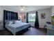Comfortable bedroom featuring hardwood floors, a ceiling fan, and natural light at 4634 Bigler Ln, Mount Dora, FL 32757