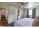 Bedroom with wood floors, a ceiling fan, a closet, and neutral walls at 4634 Bigler Ln, Mount Dora, FL 32757