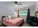 Comfortable bedroom with a ceiling fan, large window, and decorative accents at 4634 Bigler Ln, Mount Dora, FL 32757