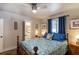 Bedroom with wood floors, bedside lamps, closet, and blue accents at 4634 Bigler Ln, Mount Dora, FL 32757
