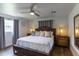 Bedroom features a ceiling fan, wood floors, and a cushioned king-sized bed at 4634 Bigler Ln, Mount Dora, FL 32757