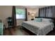Serene bedroom featuring hardwood floors, neutral paint, and a comfortable bed at 4634 Bigler Ln, Mount Dora, FL 32757