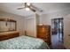 Bedroom includes wood floors, a ceiling fan, closet, and wood dressers at 4634 Bigler Ln, Mount Dora, FL 32757