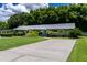 Charming home exterior with well-manicured lawn, mature trees, and colorful accent doors at 4634 Bigler Ln, Mount Dora, FL 32757
