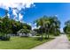 Beautiful home showcasing a long driveway, palm trees, and a well-maintained front yard at 4634 Bigler Ln, Mount Dora, FL 32757