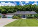 Charming home boasting a well-kept lawn, blue accents, and a spacious driveway at 4634 Bigler Ln, Mount Dora, FL 32757