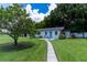 Charming home with a well-manicured lawn, inviting walkway, and mature trees at 4634 Bigler Ln, Mount Dora, FL 32757