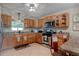 Cozy kitchen with wood cabinets, stainless steel appliances, and tile flooring at 4634 Bigler Ln, Mount Dora, FL 32757