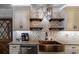 Kitchen showcasing granite countertops, copper sink, open shelving, and modern stainless steel appliances at 4634 Bigler Ln, Mount Dora, FL 32757