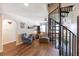 Open-concept living room features unique spiral staircase, wood floors, and bright natural light at 4634 Bigler Ln, Mount Dora, FL 32757