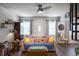 Comfortable living room with a ceiling fan, wood floors, and bright natural light at 4634 Bigler Ln, Mount Dora, FL 32757