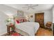 Inviting bedroom with a ceiling fan, hardwood floors, a comfortable bed, and a spacious wardrobe for a relaxing retreat at 500 Lake Forest Cir, Mount Dora, FL 32757