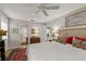 Comfortable bedroom featuring wood floors, a ceiling fan, and access to an ensuite bathroom for convenience and relaxation at 500 Lake Forest Cir, Mount Dora, FL 32757