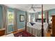 Stylish bedroom with blue walls, four-poster bed, and hardwood floors at 500 Lake Forest Cir, Mount Dora, FL 32757