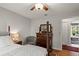 Cozy bedroom with four-poster bed, dresser, and view of the pool area at 500 Lake Forest Cir, Mount Dora, FL 32757
