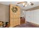 Neutral bedroom with hardwood floors, vintage wardrobe, and natural lighting at 500 Lake Forest Cir, Mount Dora, FL 32757