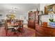 Traditional dining room featuring a chandelier, a large wooden table, and an antique china cabinet at 500 Lake Forest Cir, Mount Dora, FL 32757