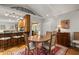 Open dining room with connection to kitchen, with wood table set on rug and vintage wooden accents at 500 Lake Forest Cir, Mount Dora, FL 32757