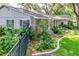 Well-maintained home with lush landscaping, stone accents, and a black metal fence at 500 Lake Forest Cir, Mount Dora, FL 32757
