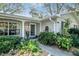 Inviting front porch with a light blue front door, lush plants, and a water feature at 500 Lake Forest Cir, Mount Dora, FL 32757