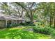 Charming home with a lush front yard, mature trees, and a manicured lawn at 500 Lake Forest Cir, Mount Dora, FL 32757