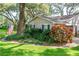 Charming home with manicured lawn, mature trees, and attractive landscaping, creating a welcoming curb appeal at 500 Lake Forest Cir, Mount Dora, FL 32757