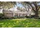 Well-maintained front yard with mature trees and stone accents on a single-story home at 500 Lake Forest Cir, Mount Dora, FL 32757