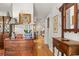 Elegant hallway with hardwood floors and antique furniture at 500 Lake Forest Cir, Mount Dora, FL 32757