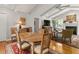 Cozy living space with wood floors, fireplace, ceiling fan, and open to dining area, creating a warm and inviting atmosphere at 500 Lake Forest Cir, Mount Dora, FL 32757