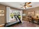 Versatile living area with treadmill, workspace, and a view of the pool at 500 Lake Forest Cir, Mount Dora, FL 32757