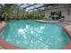Enjoy the beautiful enclosed pool with a screened enclosure, patio, and well-maintained landscaping at 500 Lake Forest Cir, Mount Dora, FL 32757