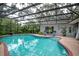 Enjoy the beautiful enclosed pool with a screened enclosure, patio, and well-maintained landscaping at 500 Lake Forest Cir, Mount Dora, FL 32757