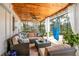 Relaxing screened porch featuring comfortable seating, stylish decor, and a beautiful wood ceiling at 500 Lake Forest Cir, Mount Dora, FL 32757