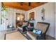 Cozy screened porch with comfortable seating, charming decor, and ample space for relaxation at 500 Lake Forest Cir, Mount Dora, FL 32757