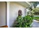 Close-up of decorative water feature on the exterior wall, with lush greenery nearby at 500 Lake Forest Cir, Mount Dora, FL 32757