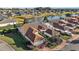 Beautiful aerial shot showcasing a well-maintained community with red-tiled roofs surrounding a scenic lake with fountain at 5046 Harbour Dr, Oxford, FL 34484