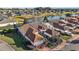 Home's boundary, featuring a private residential area with well-kept gardens, brick driveways, and a serene lake setting at 5046 Harbour Dr, Oxford, FL 34484