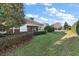 Spacious backyard with a well-maintained lawn and mature trees, offering privacy and a peaceful environment at 5046 Harbour Dr, Oxford, FL 34484