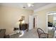 Bright bedroom with neutral walls, carpeted floor and ceiling fan, complemented by a small accent table with decorative lamp at 5046 Harbour Dr, Oxford, FL 34484