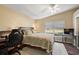 Bedroom with ceiling fan, wood floors, desk, bed, and light beige color scheme, offering a serene retreat at 5046 Harbour Dr, Oxford, FL 34484
