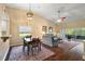 Open-concept dining area with hardwood floors, modern lighting, and views of the living room at 5046 Harbour Dr, Oxford, FL 34484