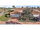 Charming single-story home with a red brick driveway, tile roof, and well-manicured landscaping at 5046 Harbour Dr, Oxford, FL 34484