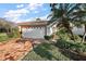 Inviting single-story home featuring a tile roof, red brick driveway, and a meticulously landscaped yard at 5046 Harbour Dr, Oxford, FL 34484