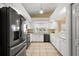Modern kitchen featuring black stainless steel appliances, white cabinetry, and ample counter space at 5046 Harbour Dr, Oxford, FL 34484