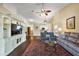 Cozy living room with a vaulted ceiling, hardwood floors, and a stylish entertainment center at 5046 Harbour Dr, Oxford, FL 34484