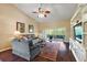 Inviting living room with high ceilings, hardwood floors, and a sliding glass door to the patio at 5046 Harbour Dr, Oxford, FL 34484