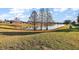 Scenic view of a tranquil pond surrounded by lush greenery and mature trees in a neighborhood at 5046 Harbour Dr, Oxford, FL 34484
