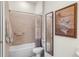 Bathroom with tiled shower and tub combination, complemented by a modern mirror at 5090 Greens Dr, Lady Lake, FL 32159