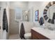 Bathroom with a modern vanity, decorative mirror, and glass-enclosed shower at 5090 Greens Dr, Lady Lake, FL 32159